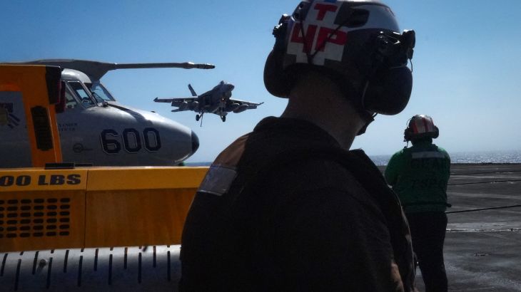 US Navy flight deck crew member watch as an F/A-18 Super Hornet lands aboard the aircraft carrier USS Theodore Roosevelt (CVN-71) while the ship is moored in Honolulu, Hawaii, during Exercise RIMPAC (Rim of the Pacific) 2026 on July 17, 2026. (Photo by Michelle Bir / AFP)